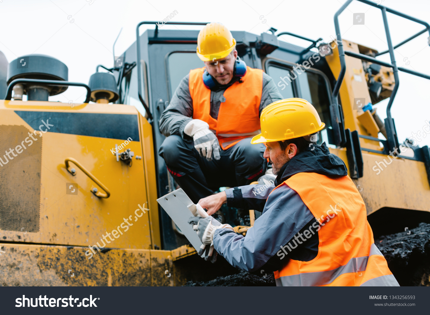 stock-photo-worker-sitting-on-heavy-excavation-machinery-in-mining-operation-1343256593